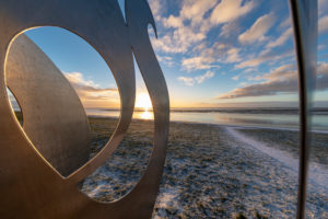 Sunrise on the south beach, sculpture, detail, wave over the wall by Werner Reichhold made of V2A steel, south beach, Wilhelmshaven, Lower Saxony, Sunrise on the south beach, sculpture, detail, wave over the wall by Werner Reichhold made of V2A steel, south beach, Wilhelmshaven, Lower Saxony,